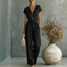 Svart jumpsuit med korta ärmar och elegant siluett